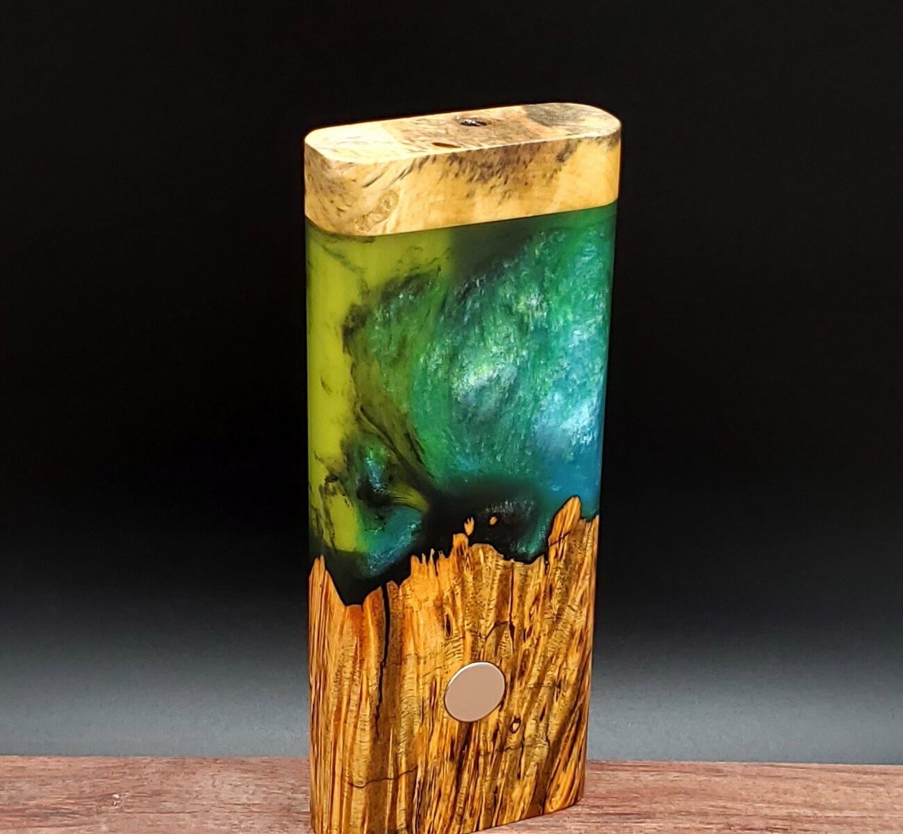 This image portrays Luminescent Cosmic Burl Dynavap Stash Case by Dovetail Woodwork.