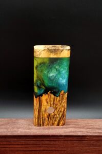 This image portrays Luminescent Cosmic Burl Dynavap Stash Case by Dovetail Woodwork.