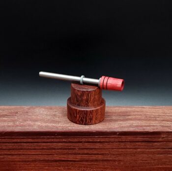 This image portrays Dynavap Spinning Mouthpiece-Redheart Wood by Dovetail Woodwork.