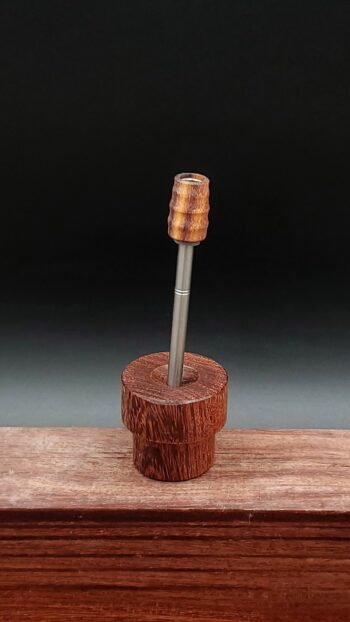 This image portrays Dynavap Spinning Mouthpiece-Curupau Wood-UV/Black Light Reactive! by Dovetail Woodwork.