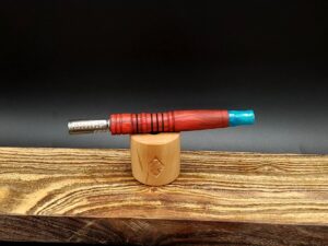 This image portrays Luminescent Dynavap Spinning Mouthpiece-Cosmic Resin by Dovetail Woodwork.