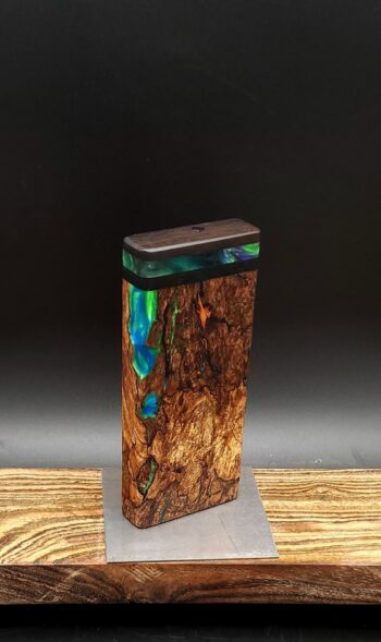 This image portrays Luminescent Cosmic Burl-Dynavap Stash Case by Dovetail Woodwork.