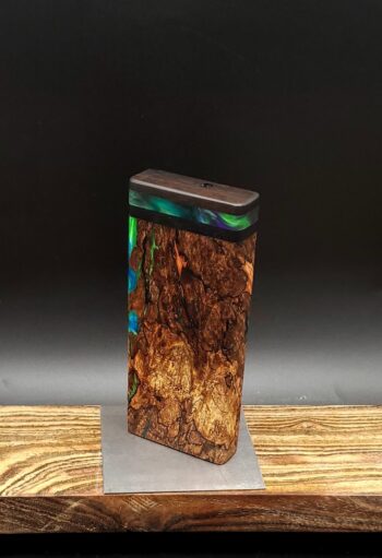 This image portrays Luminescent Cosmic Burl-Dynavap Stash Case by Dovetail Woodwork.