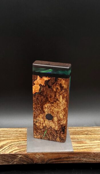 This image portrays Luminescent Cosmic Burl-Dynavap Stash Case by Dovetail Woodwork.