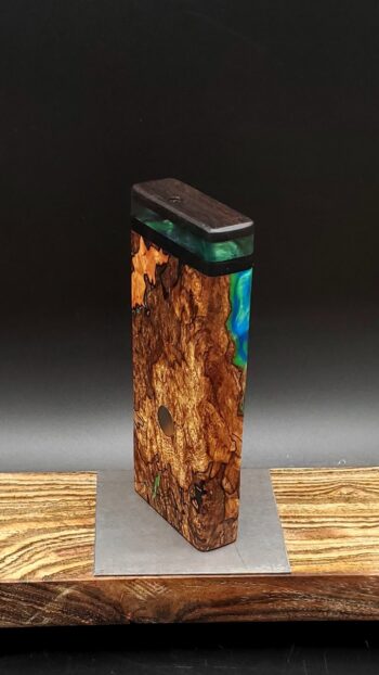 This image portrays Luminescent Cosmic Burl-Dynavap Stash Case by Dovetail Woodwork.