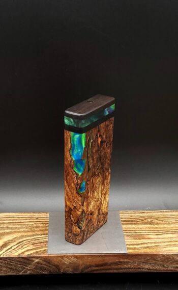 This image portrays Luminescent Cosmic Burl-Dynavap Stash Case by Dovetail Woodwork.