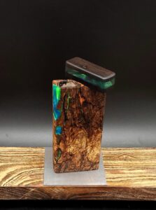 This image portrays Luminescent Cosmic Burl-Dynavap Stash Case by Dovetail Woodwork.