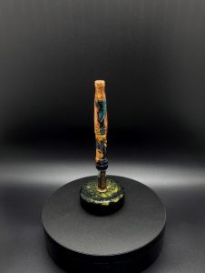 This image portrays Luminescent Cosmic Series-Buckeye Burl Hybrid-XL Dynavap Stem by Dovetail Woodwork.