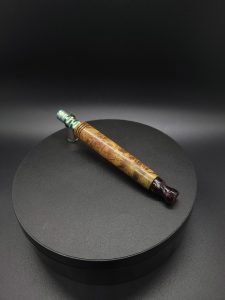 This image portrays Green Cosmic Burl XL-Titanium Core-Dynavap Stem by Dovetail Woodwork.