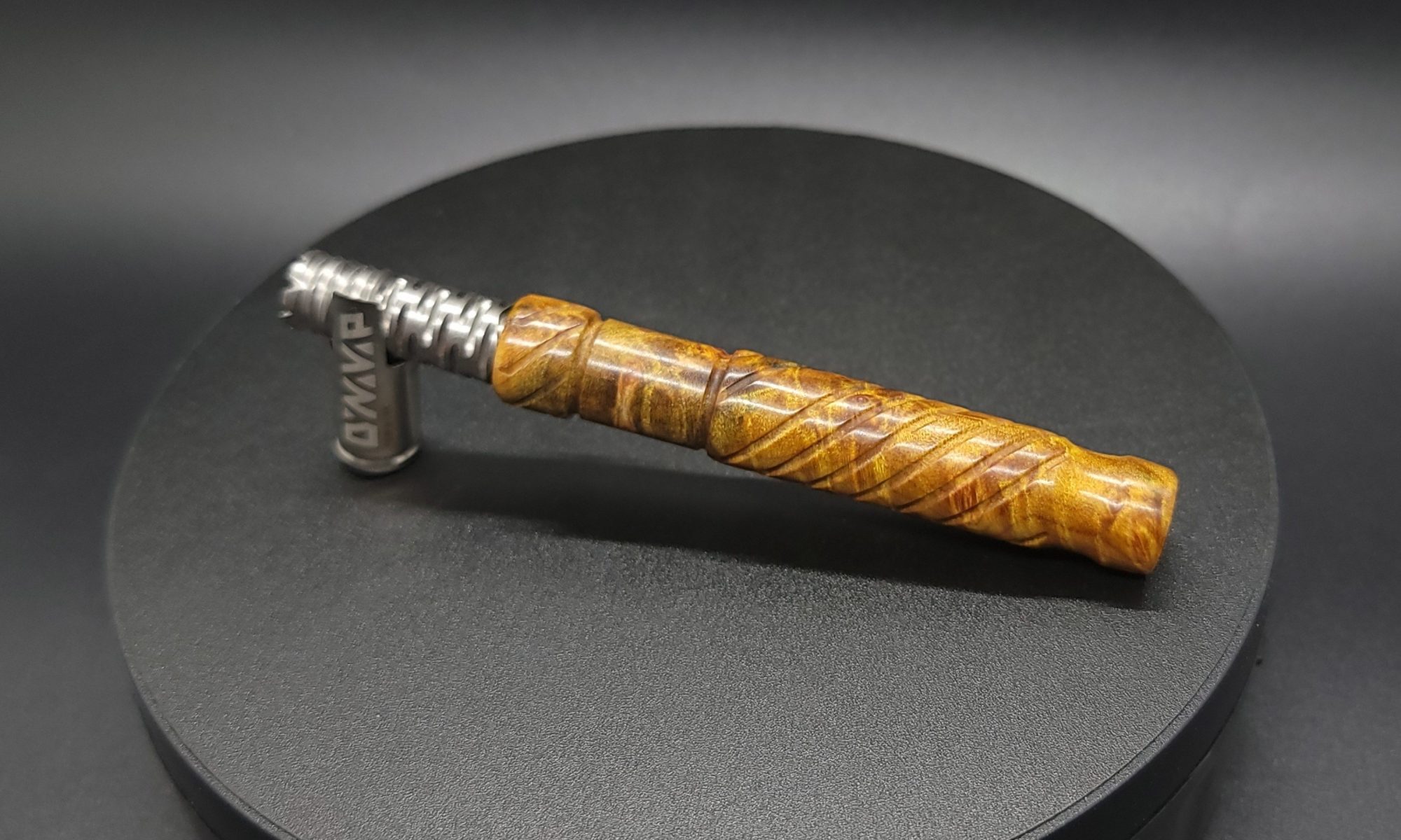 This image portrays Straight Cut XL-Maple Burl/Gold Anodized Titanium-Dynavap Stem by Dovetail Woodwork.