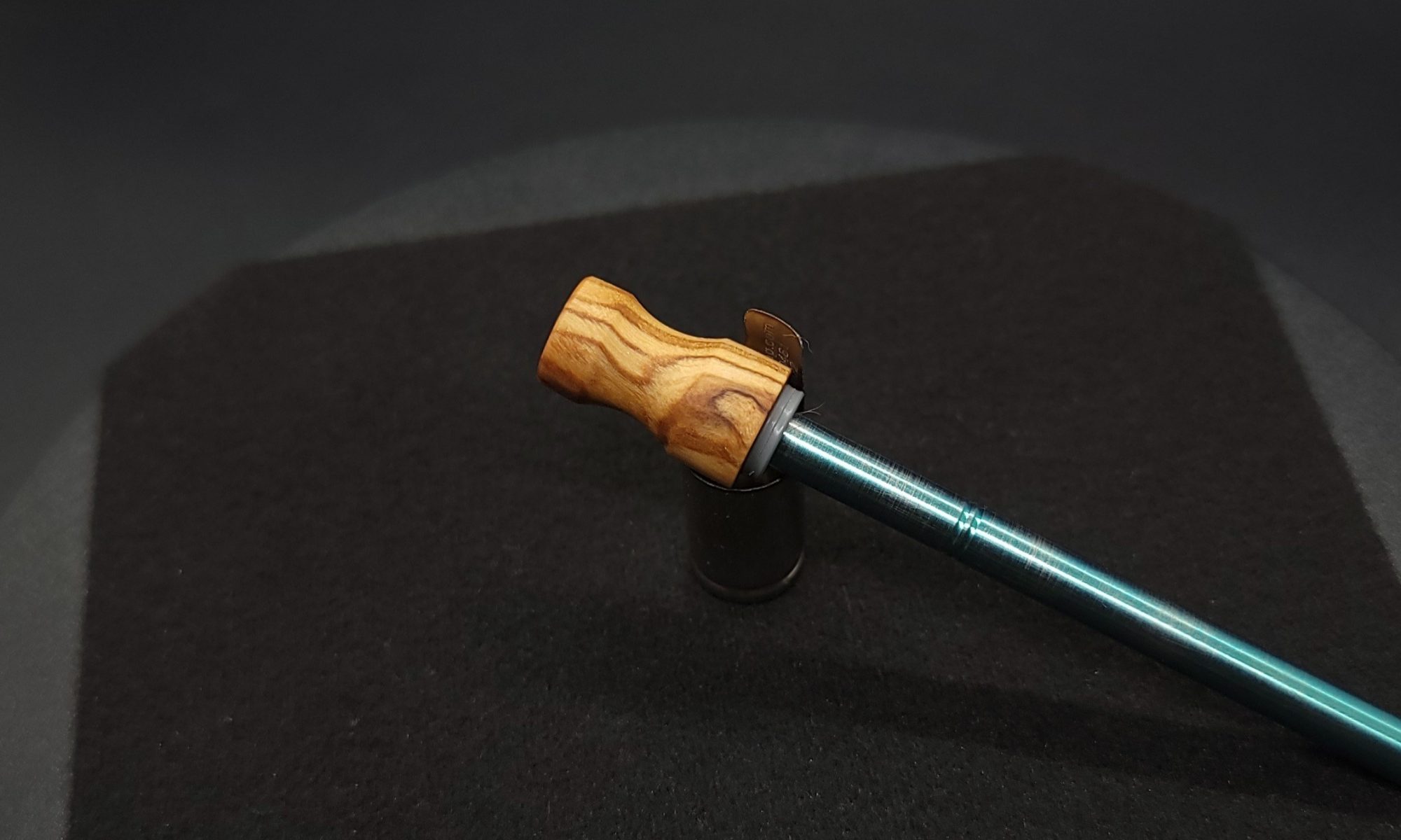 This image portrays Dynavap Spinning Mouthpiece-Olive Wood Burl by Dovetail Woodwork.