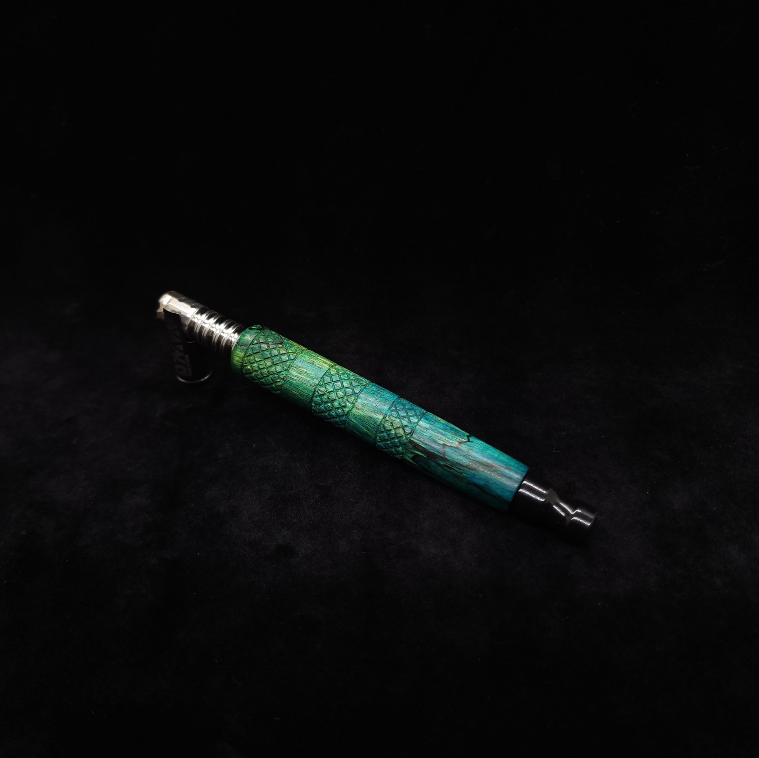 This image portrays High Class-Knurled XL Dynavap Stem/Spalted Tamarind/Blue to Green with Black Mouthpiece by Dovetail Woodwork.