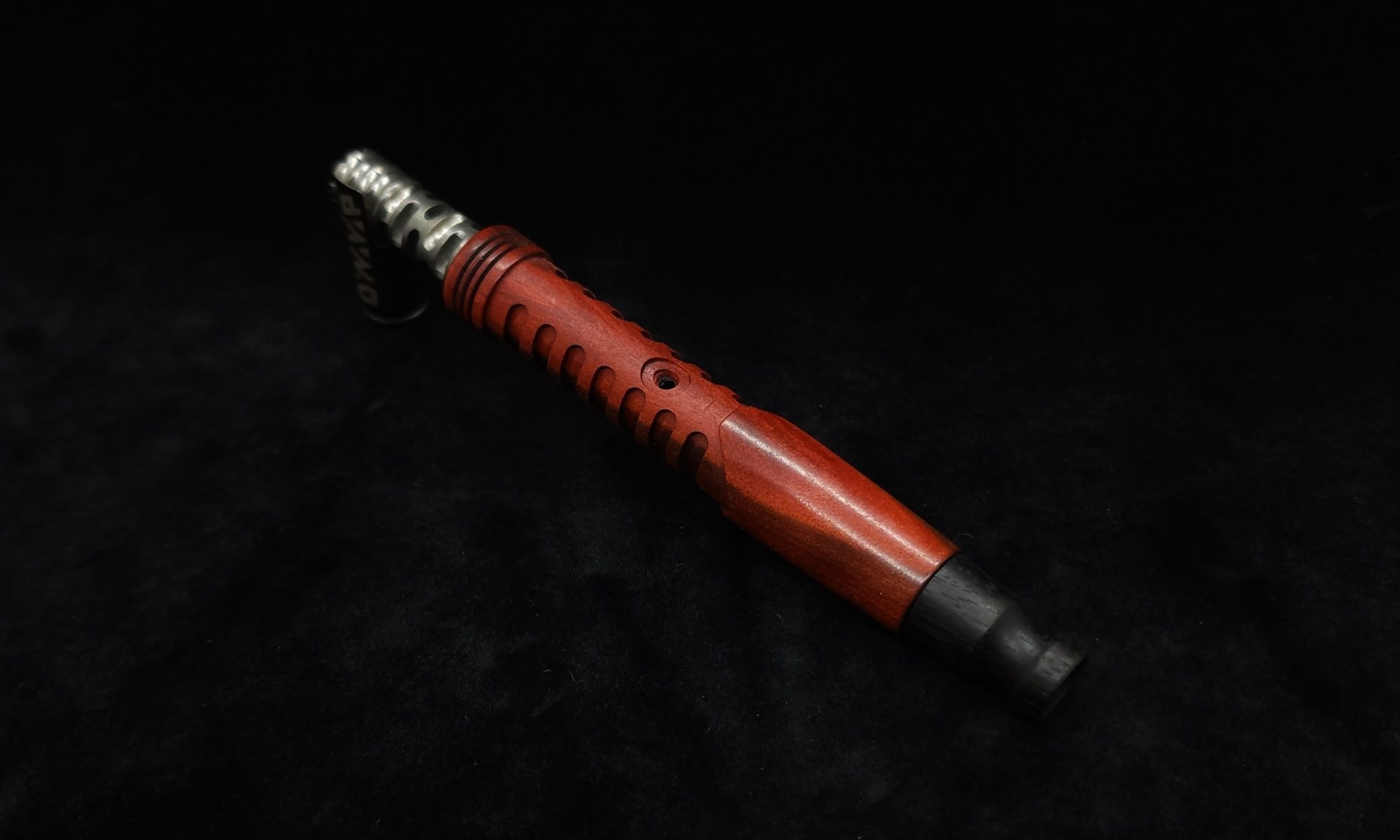 This image portrays Lightsaber Hilt/XL Dynavap Stem + Redheart Wood + Ebony M.P. by Dovetail Woodwork.