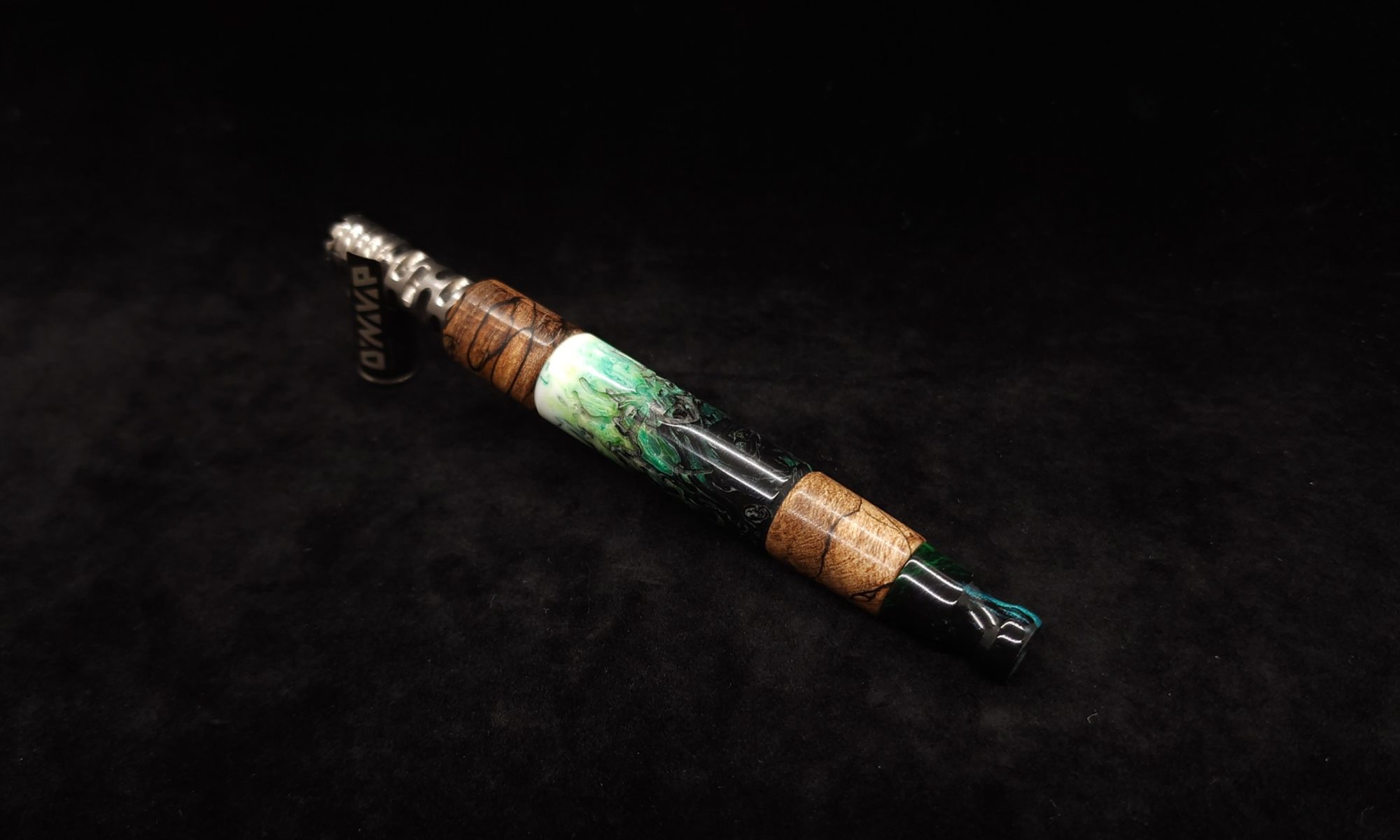 This image portrays Luminescent Widow Dynavap Stem XL-Hybrid + M.P. by Dovetail Woodwork.