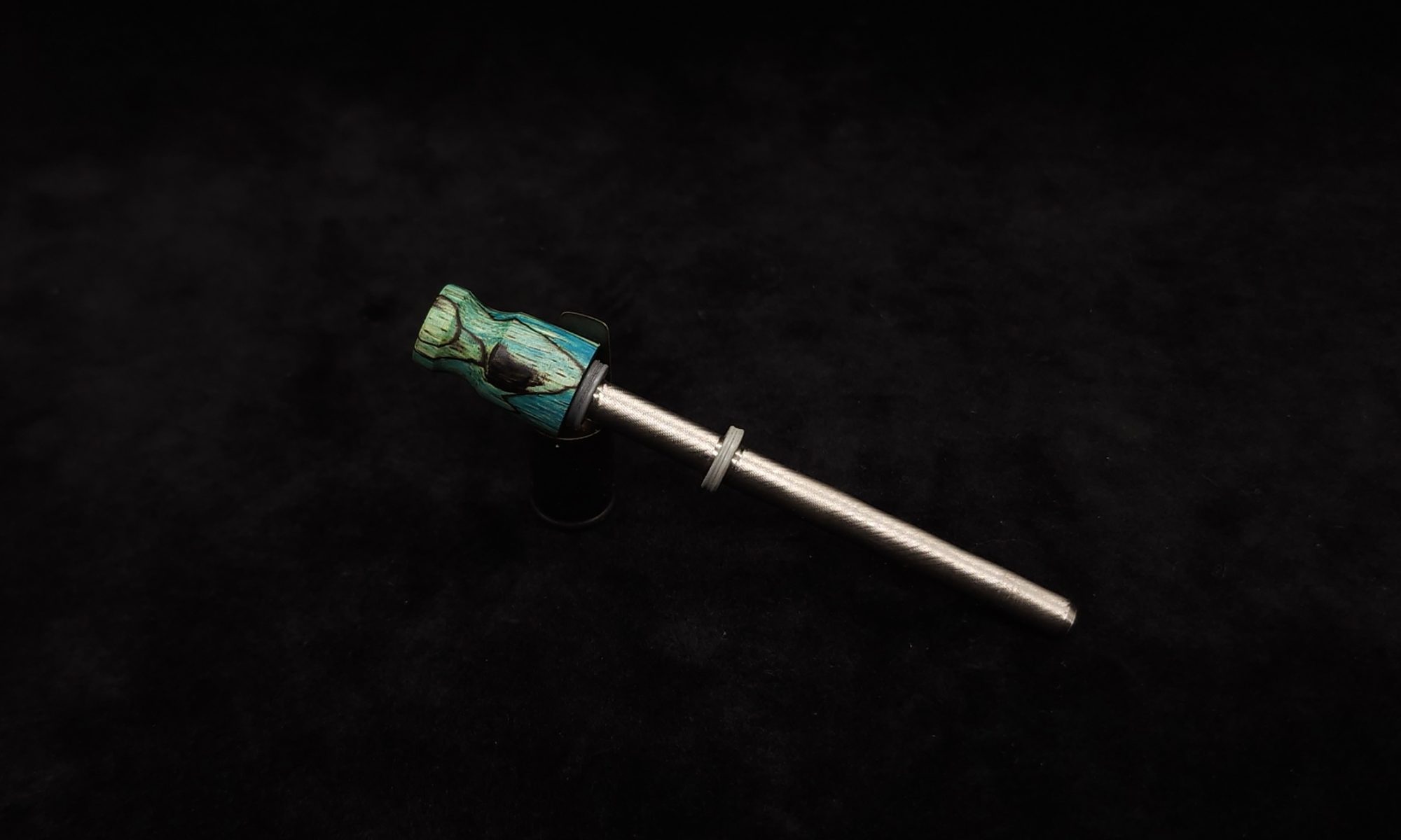 This image portrays Dynavap Spinning Mouthpiece-Blue/Teal Spalted Tamarind by Dovetail Woodwork.