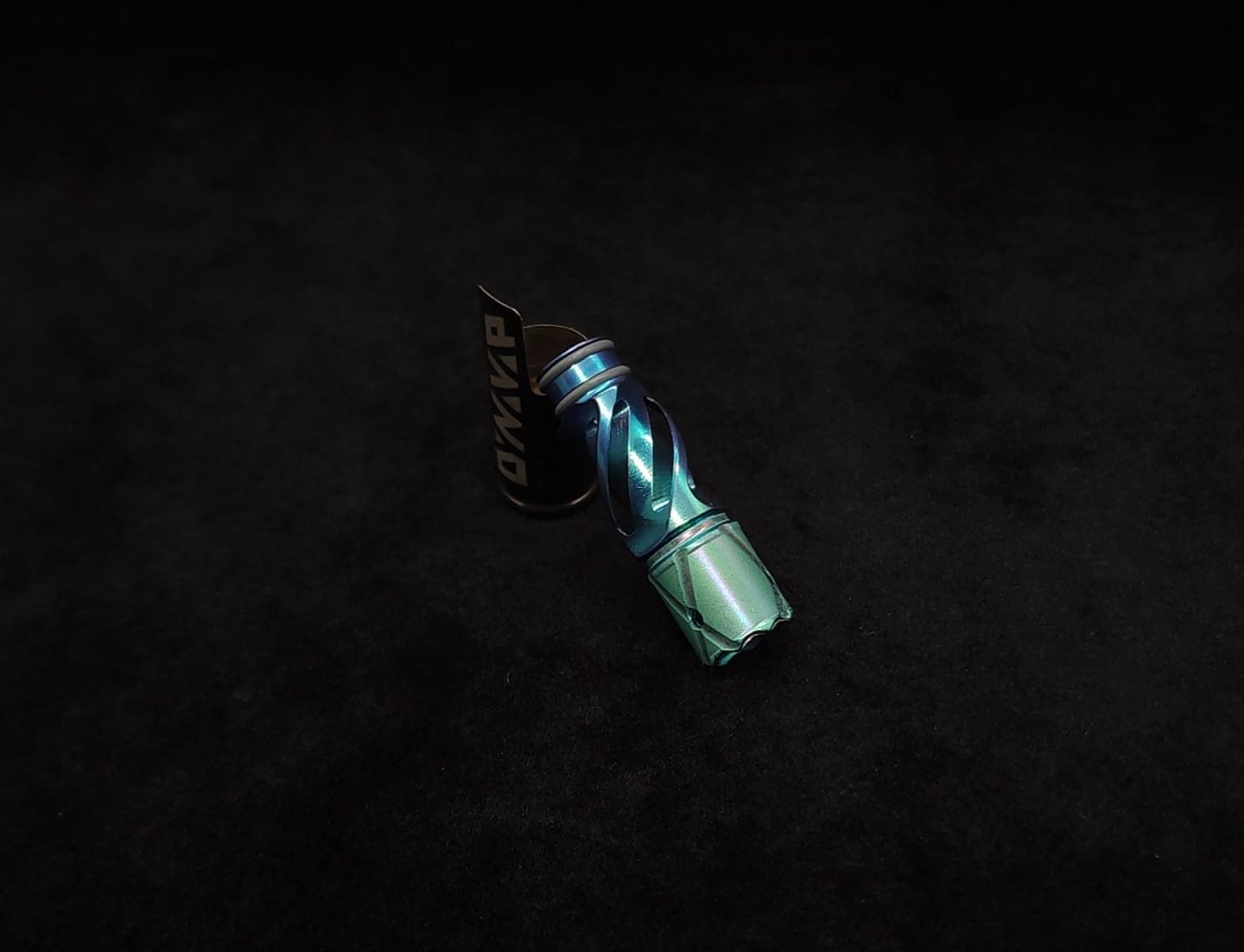 This image portrays Titanium Tip: HELIX-Color Fade-Green to Aqua Anodized by Dovetail Woodwork.