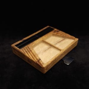 This image portrays DynaTray-Dynavap Stem Display Holder/Sorting Tray-Black Limba by Dovetail Woodwork.