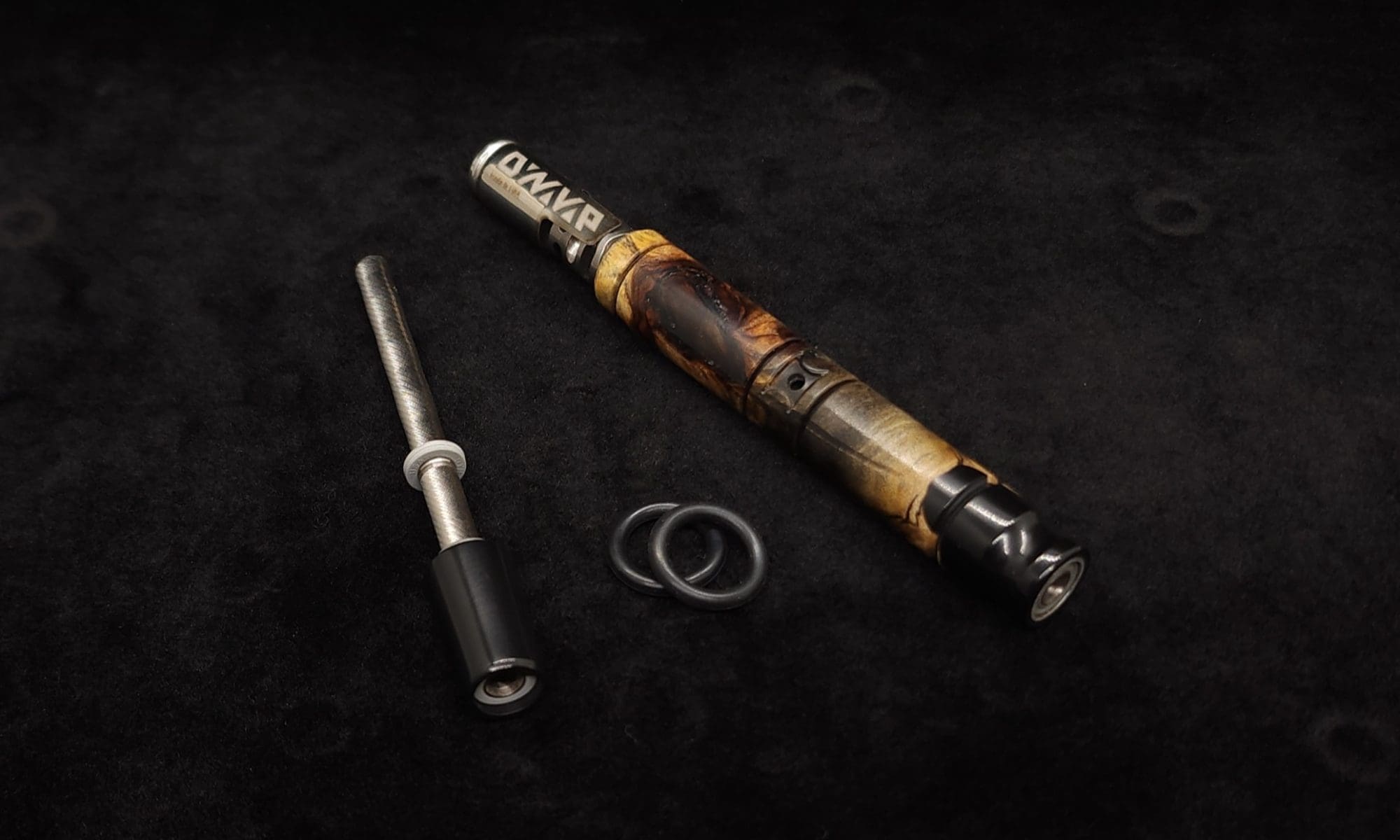 This image portrays Attenuated Dynavap XL Burl Hybrid Stem + Matching Mouthpiece by Dovetail Woodwork.